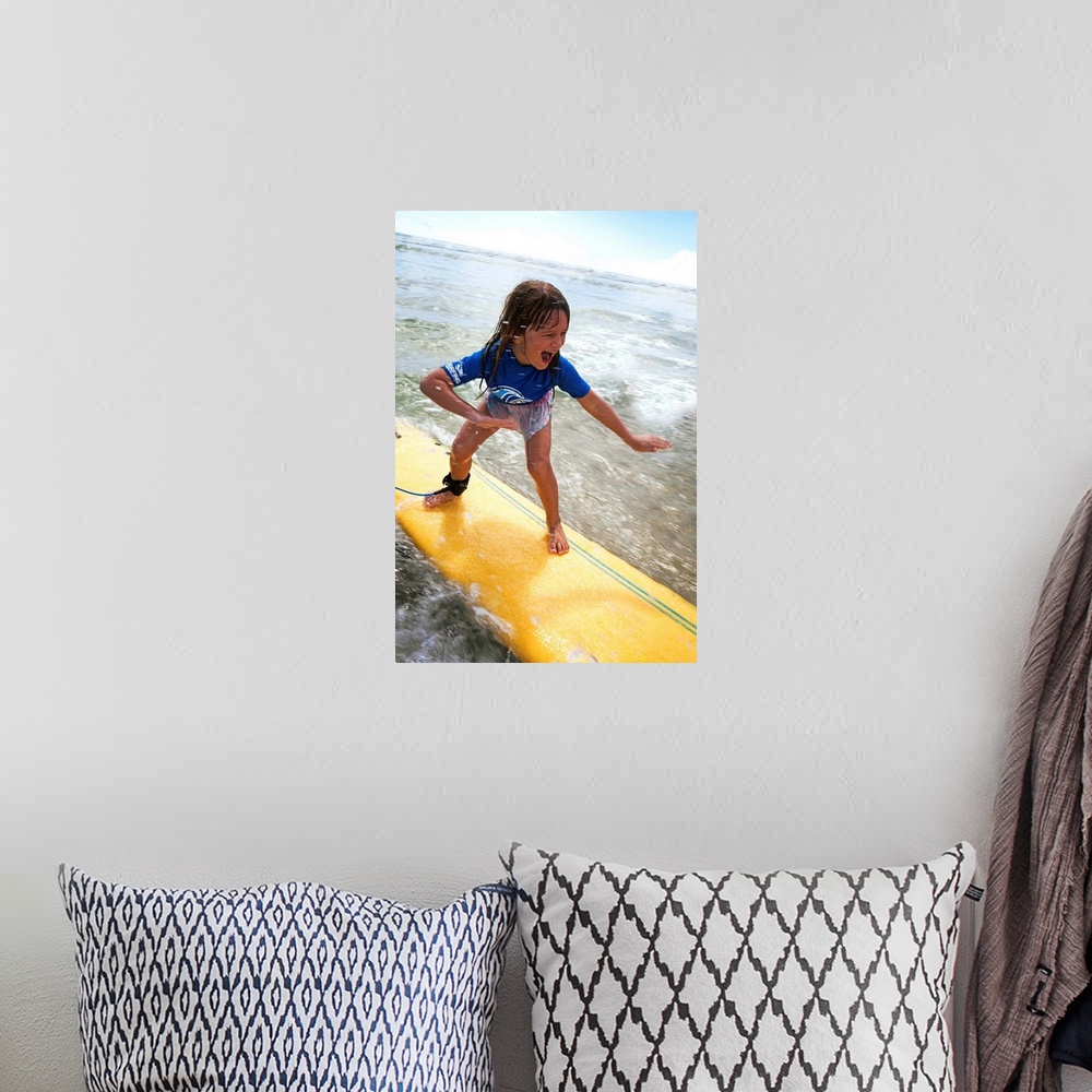 A bohemian room featuring A young girl on a yellow surfboard, Gold Coast, Queensland, Australia