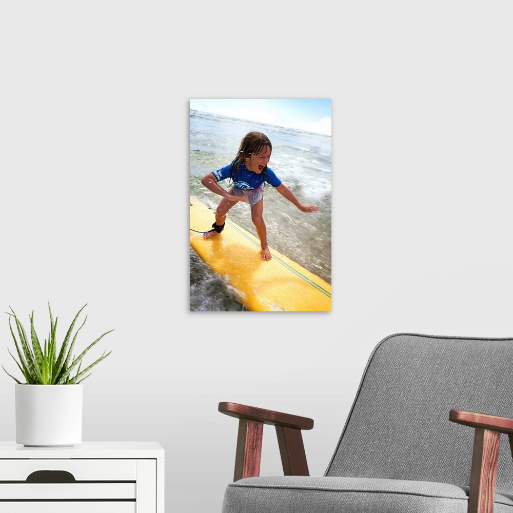 A modern room featuring A young girl on a yellow surfboard, Gold Coast, Queensland, Australia