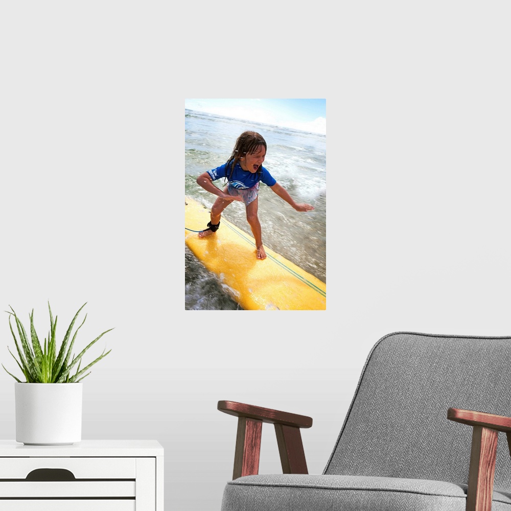 A modern room featuring A young girl on a yellow surfboard, Gold Coast, Queensland, Australia
