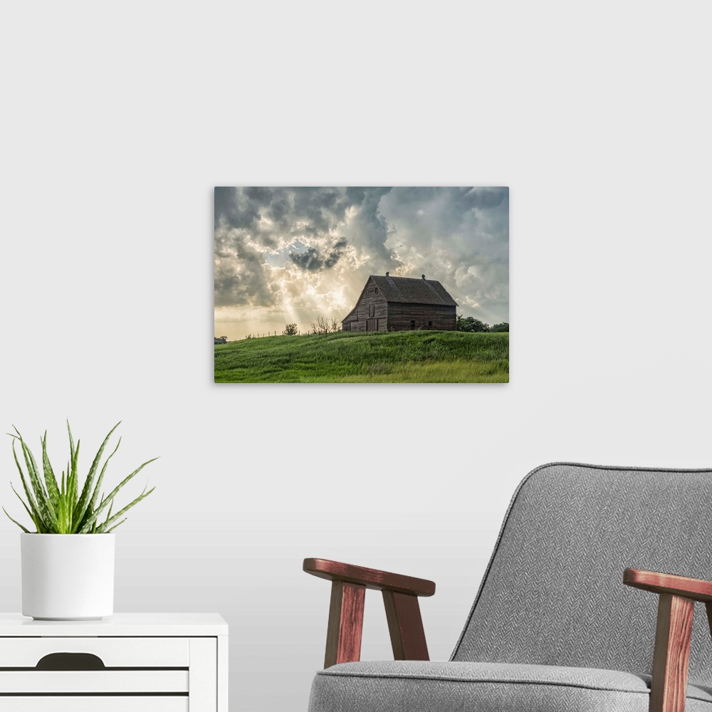 A modern room featuring Abandoned barn with storm clouds converging overhead; Nebraska, United States of America