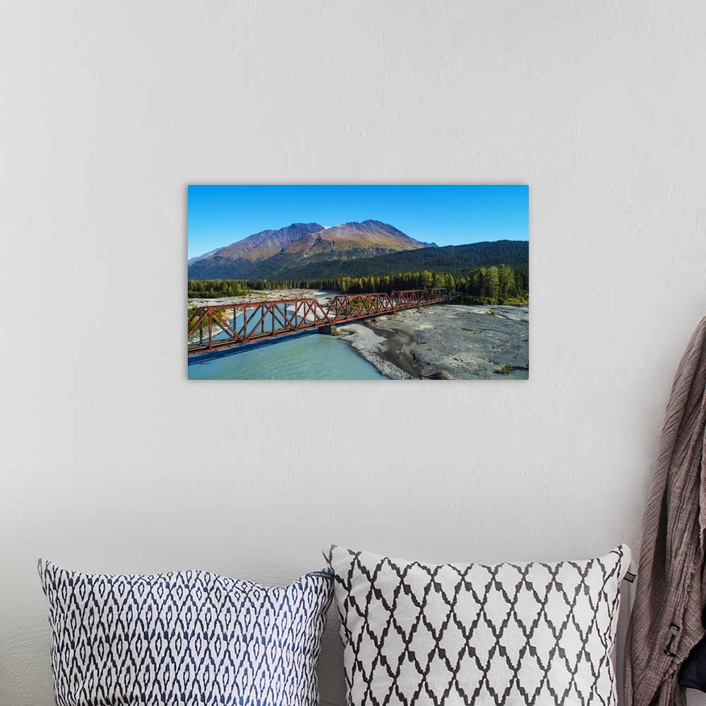 A bohemian room featuring An aerial scenic of the Alaskan Railroad trestle crossing the Snow River on a sunny summer day in...