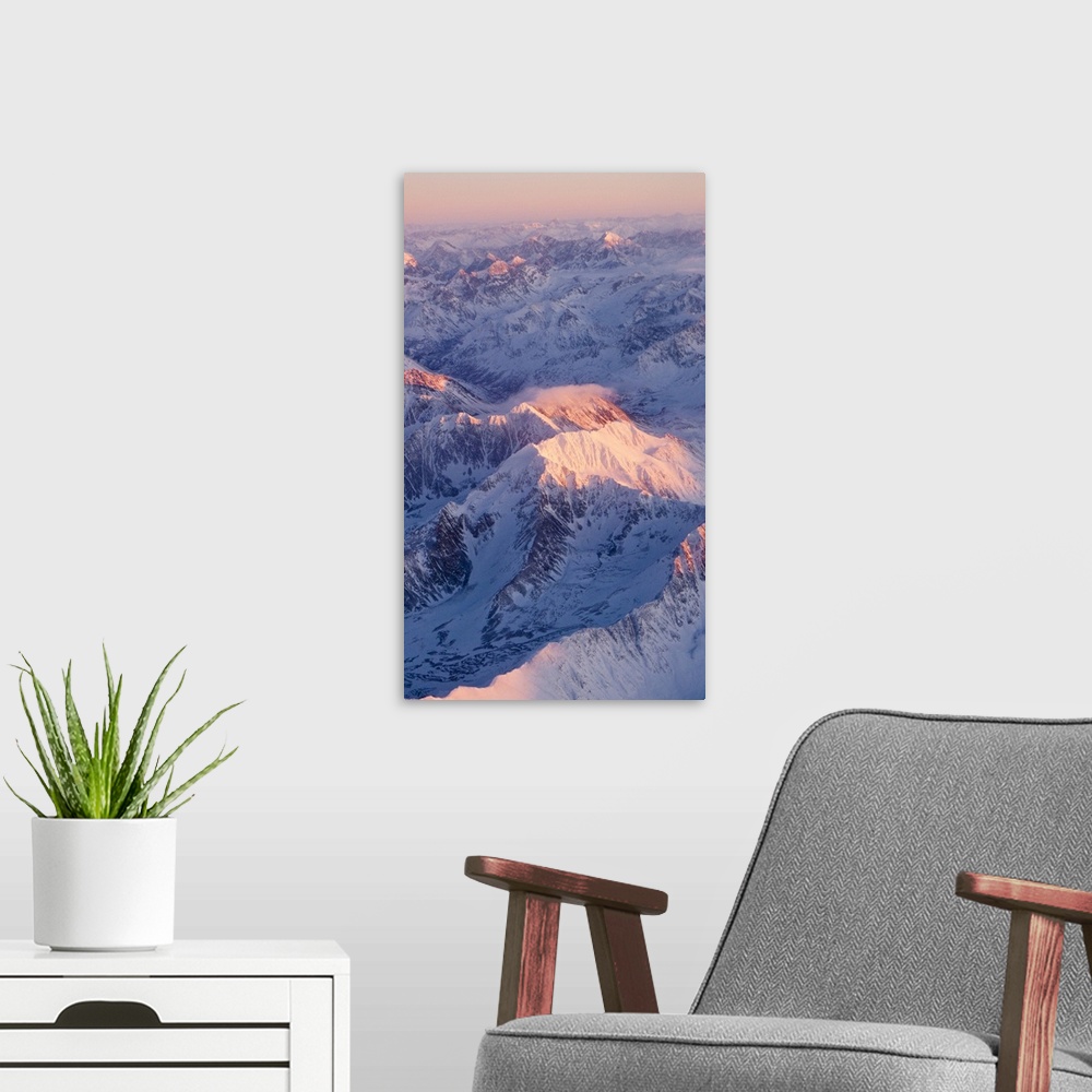 A modern room featuring Aerial view of the Chugach Mountain range with sunrise alpenglow hitting the peaks during Winter ...