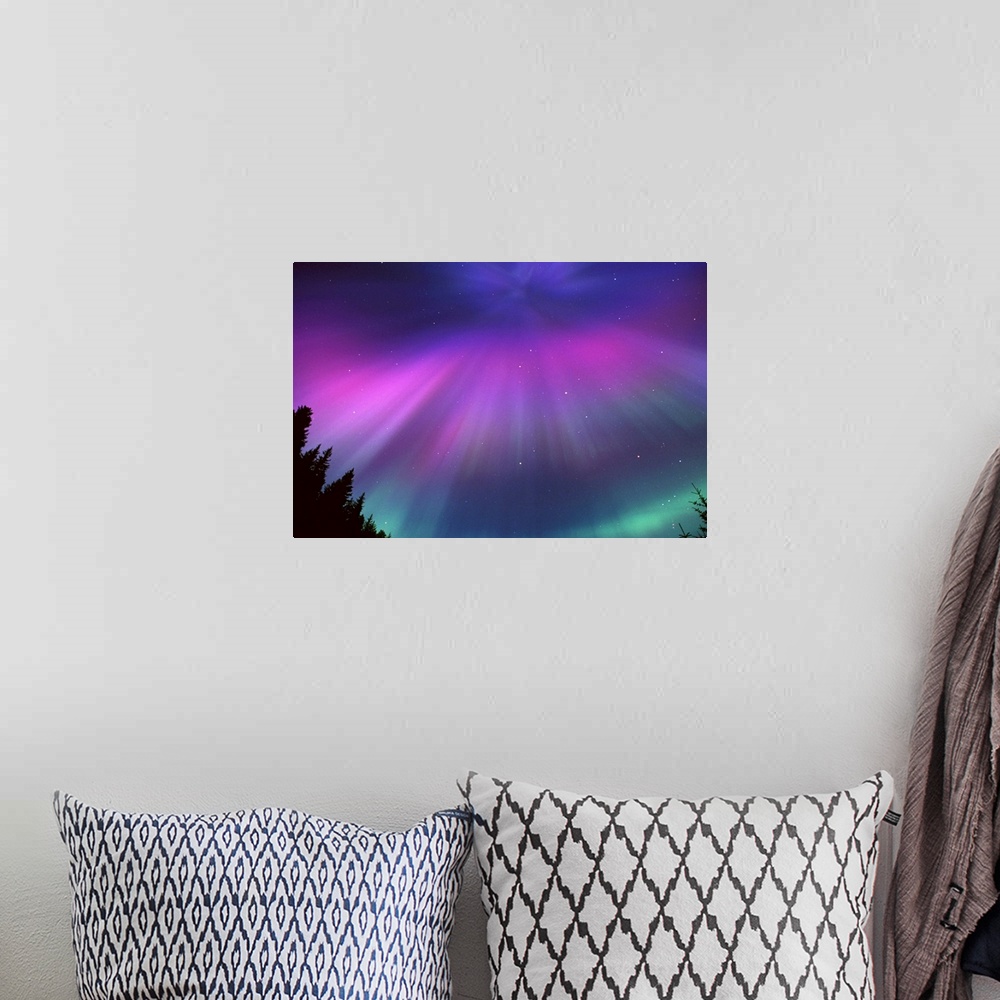 A bohemian room featuring This landscape photograph captures the glow of the Northern lights and the speckles of stars beyo...