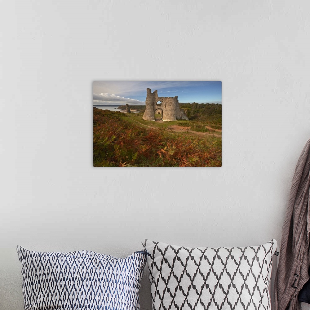 A bohemian room featuring Autumnal view of the ruins of Pennard Castle.