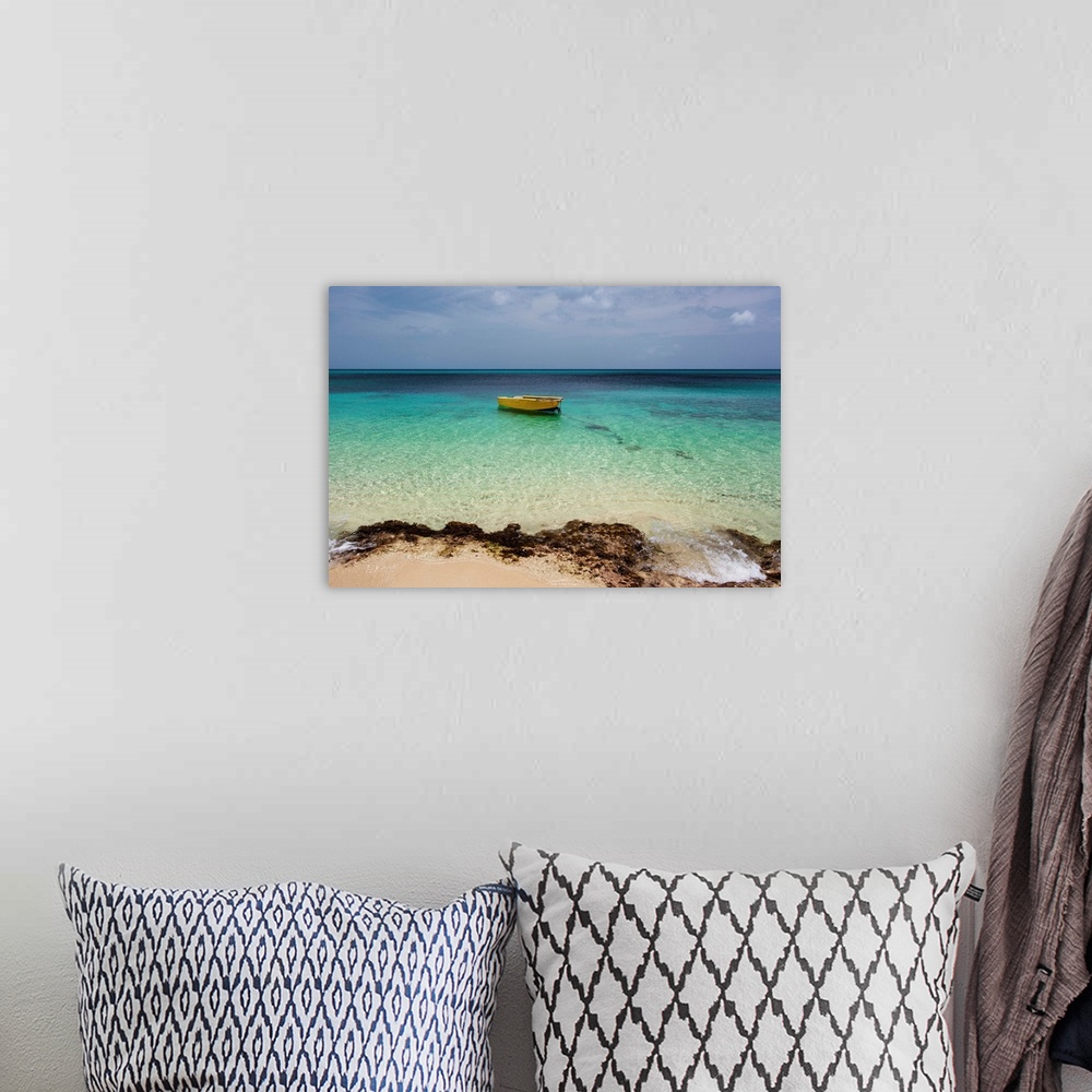 A bohemian room featuring A lone boat in the turquoise water off a tropical island, Frederiksted, St. Croix, Virgin Islands...