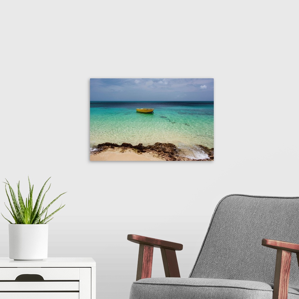 A modern room featuring A lone boat in the turquoise water off a tropical island, Frederiksted, St. Croix, Virgin Islands...