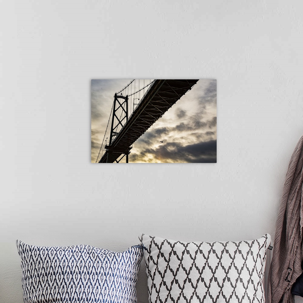 A bohemian room featuring Low angle view of a bridge at sunset with an airplane flying in the distance; Vancouver, British ...