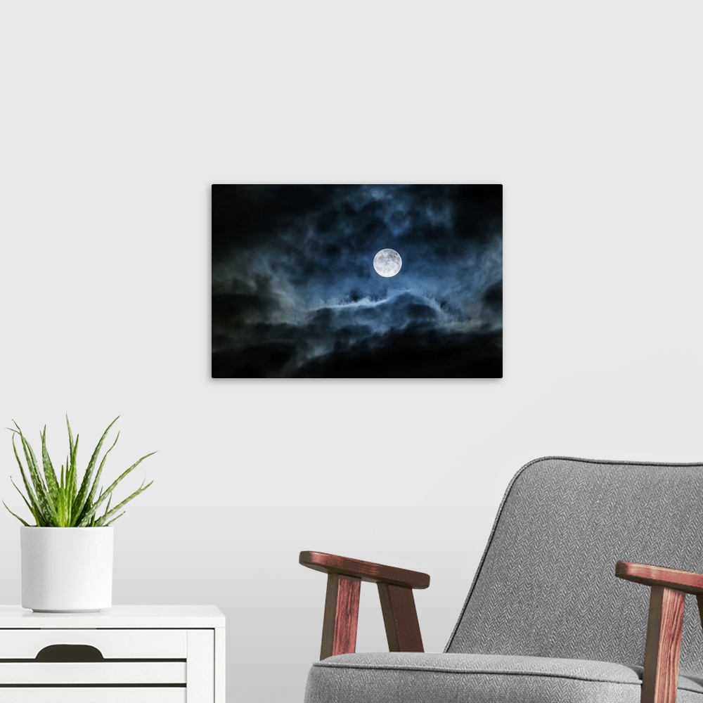 A modern room featuring Bright full moon glowing in a cloudy sky; Ontario, Canada