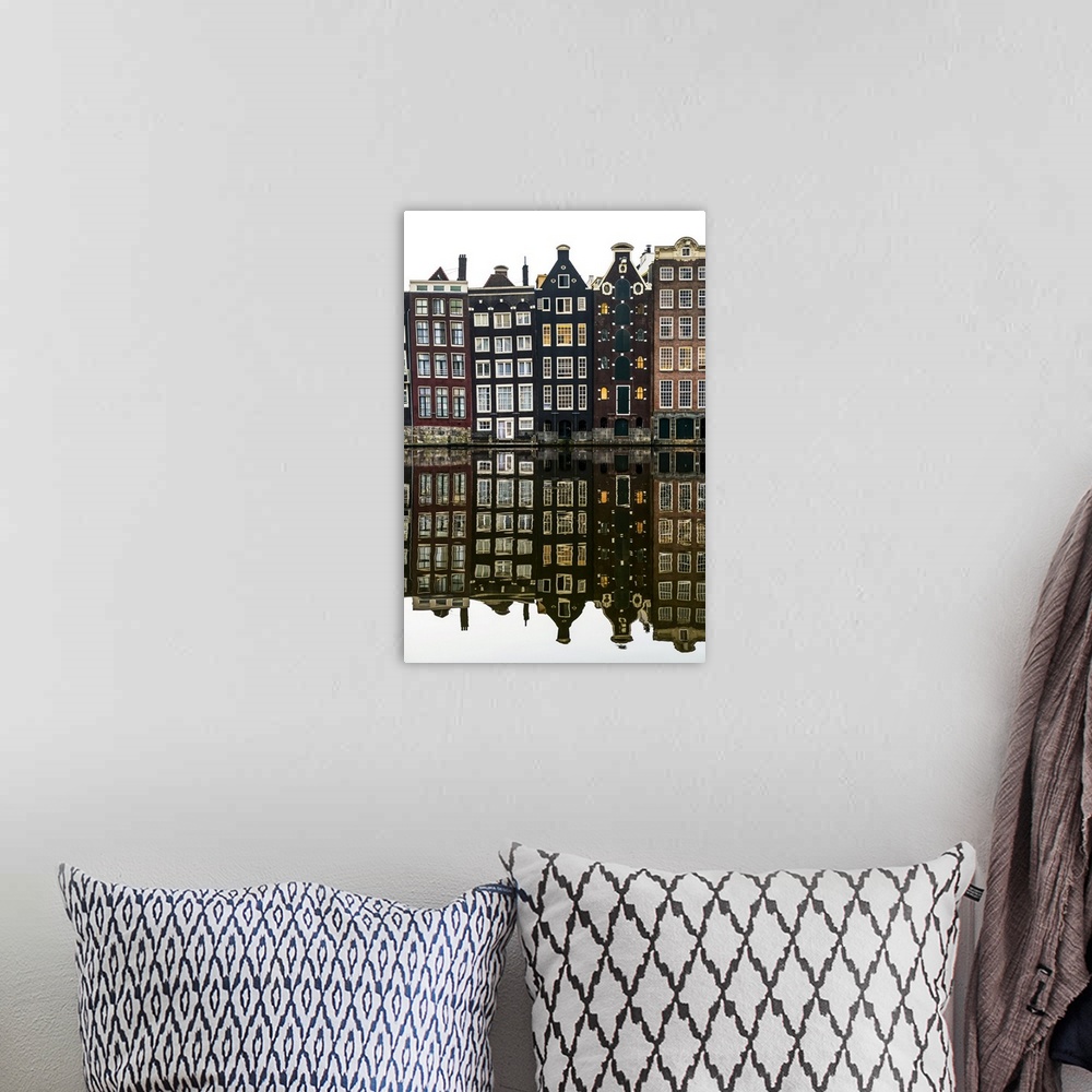 A bohemian room featuring Building facades with a mirror image reflecting in a canal; Amsterdam, Netherlands