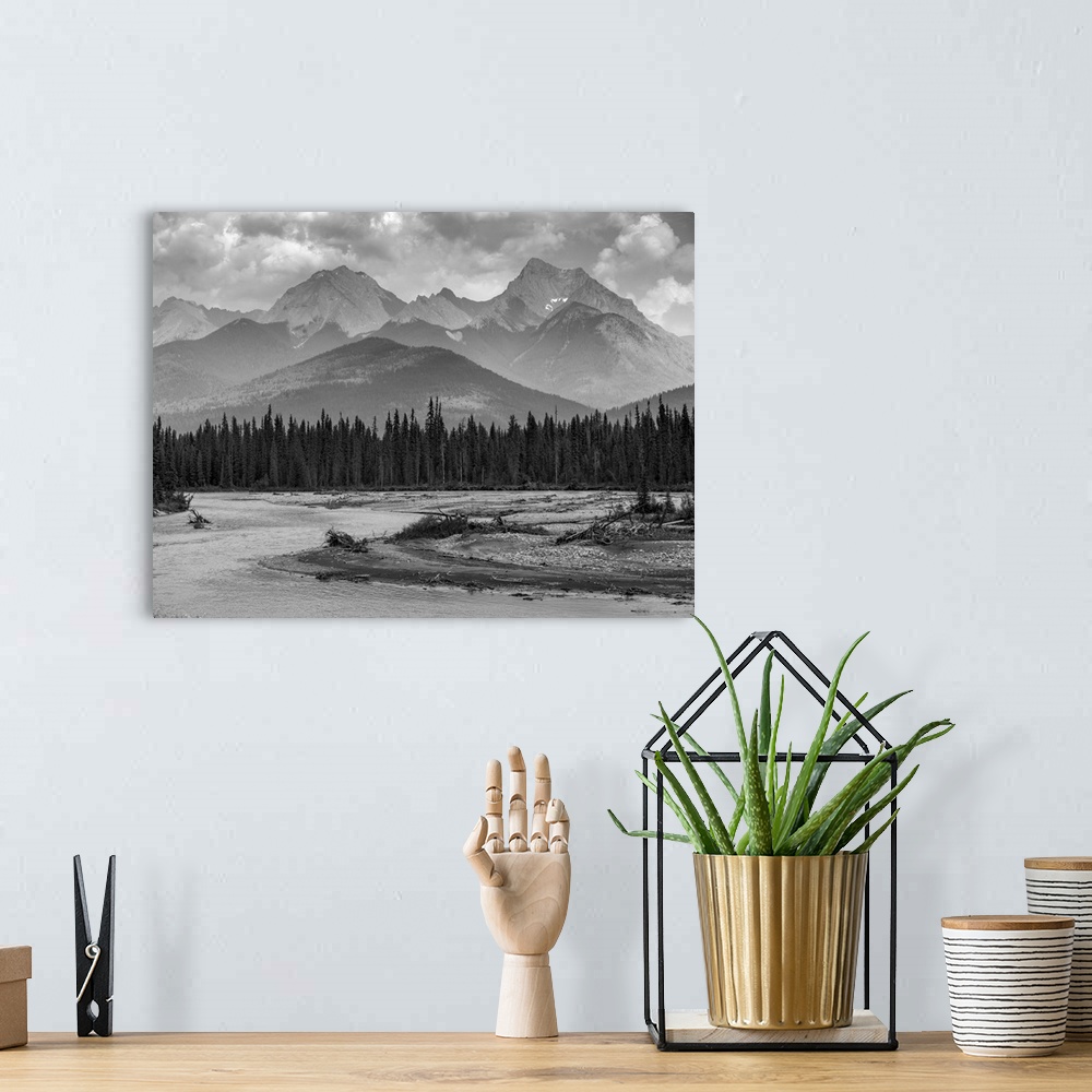 A bohemian room featuring Black and white landscape of the rugged Canadian rocky mountains with a forest and a flowing rive...