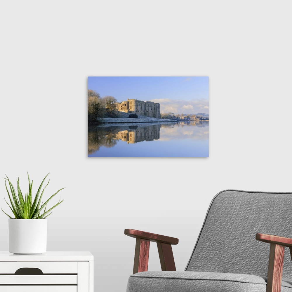 A modern room featuring Carew Castle in winter.