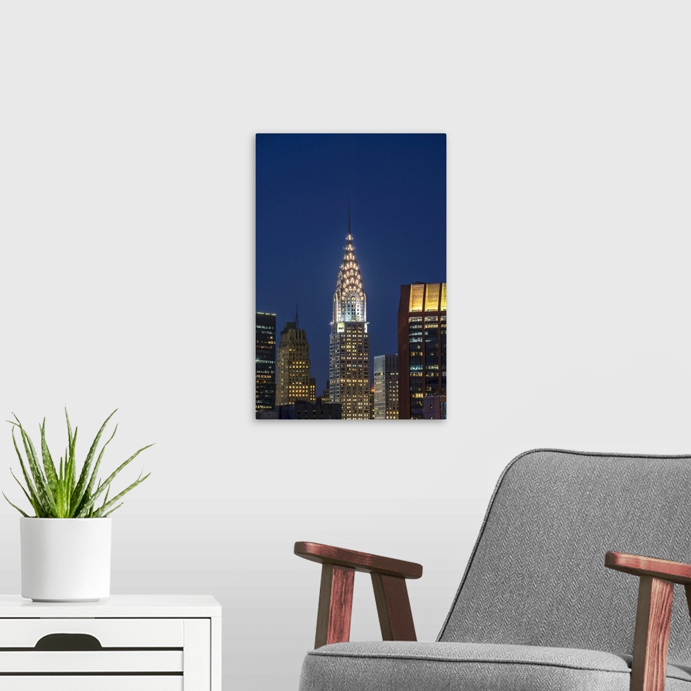 A modern room featuring Chrysler Building at twilight. New York City, New York, United States of America.