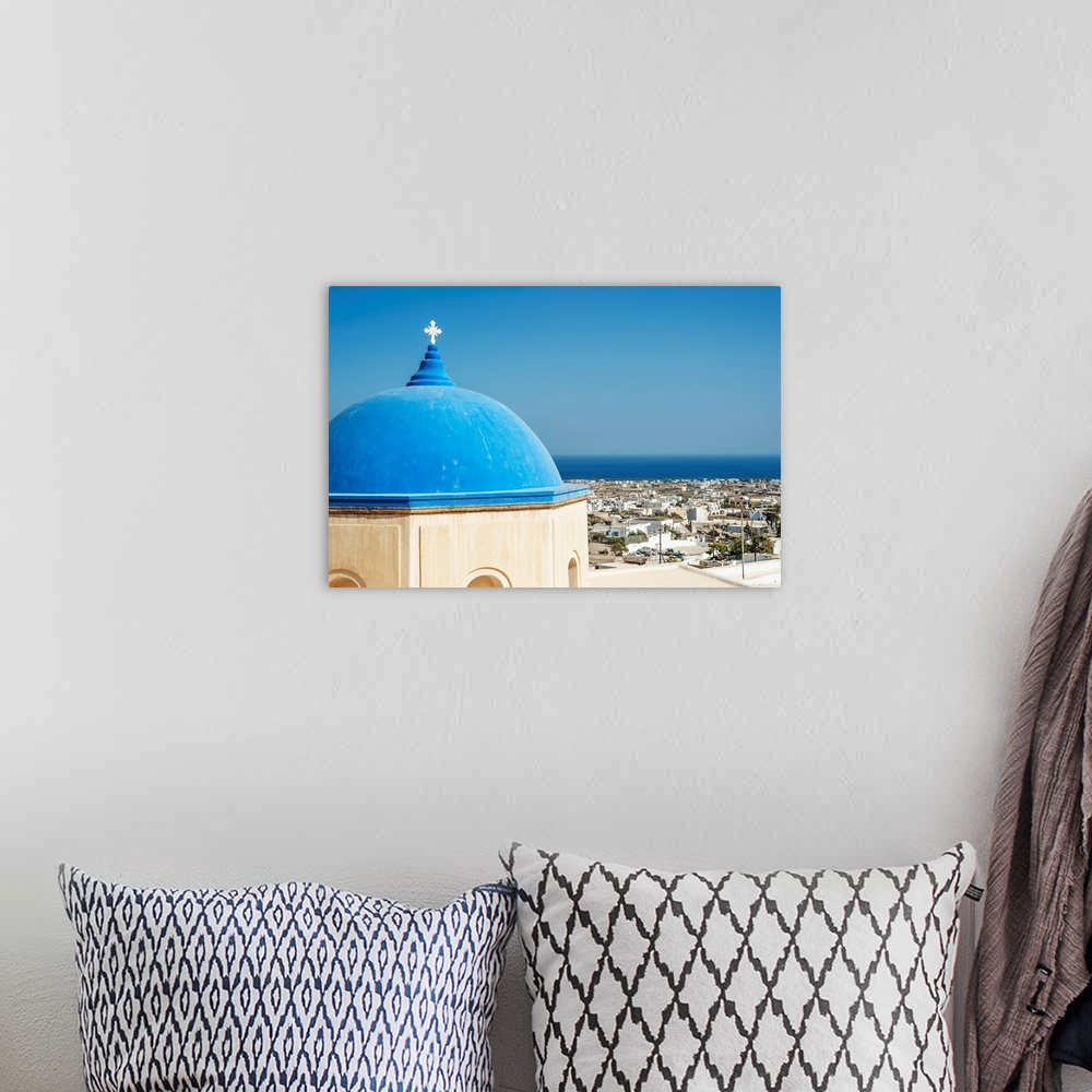 A bohemian room featuring Church with a blue dome roof and view of the Aegean sea, Megalochori, Santorini, Greece