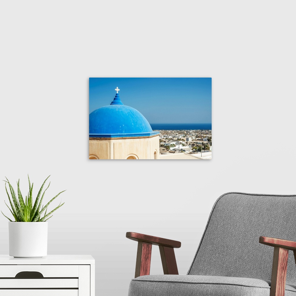 A modern room featuring Church with a blue dome roof and view of the Aegean sea, Megalochori, Santorini, Greece