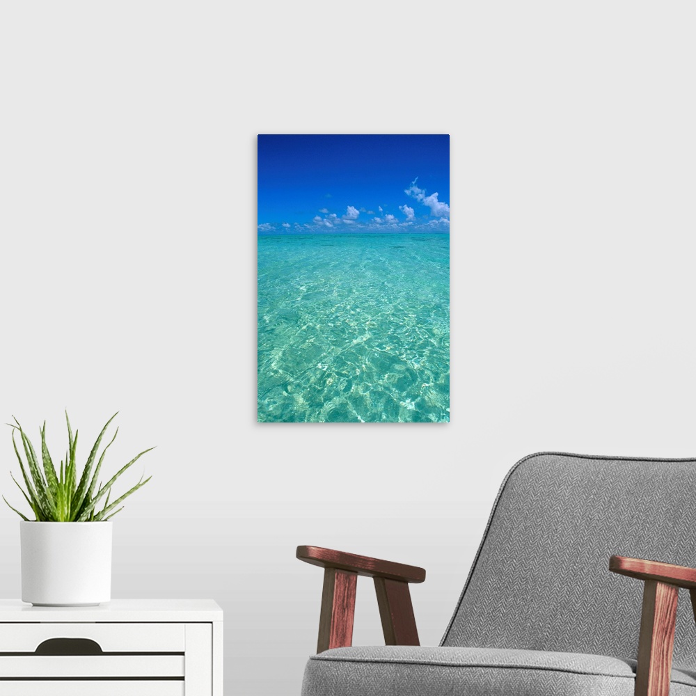 A modern room featuring Clear Turquoise Ocean Water, Blue Sky, White Clouds