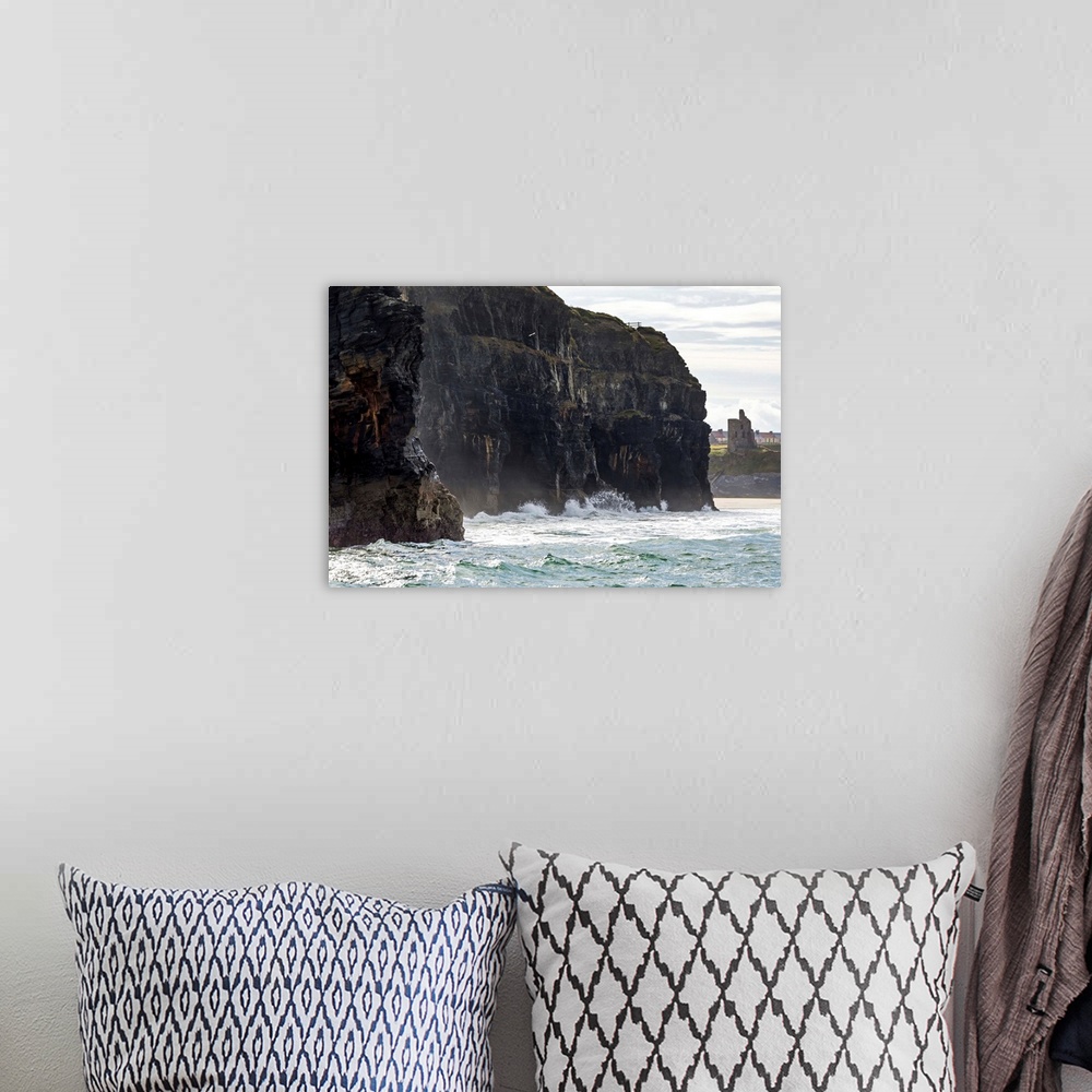 A bohemian room featuring Dark straight cliffs with waves crashing into the rock with ruined castle turret in background, B...
