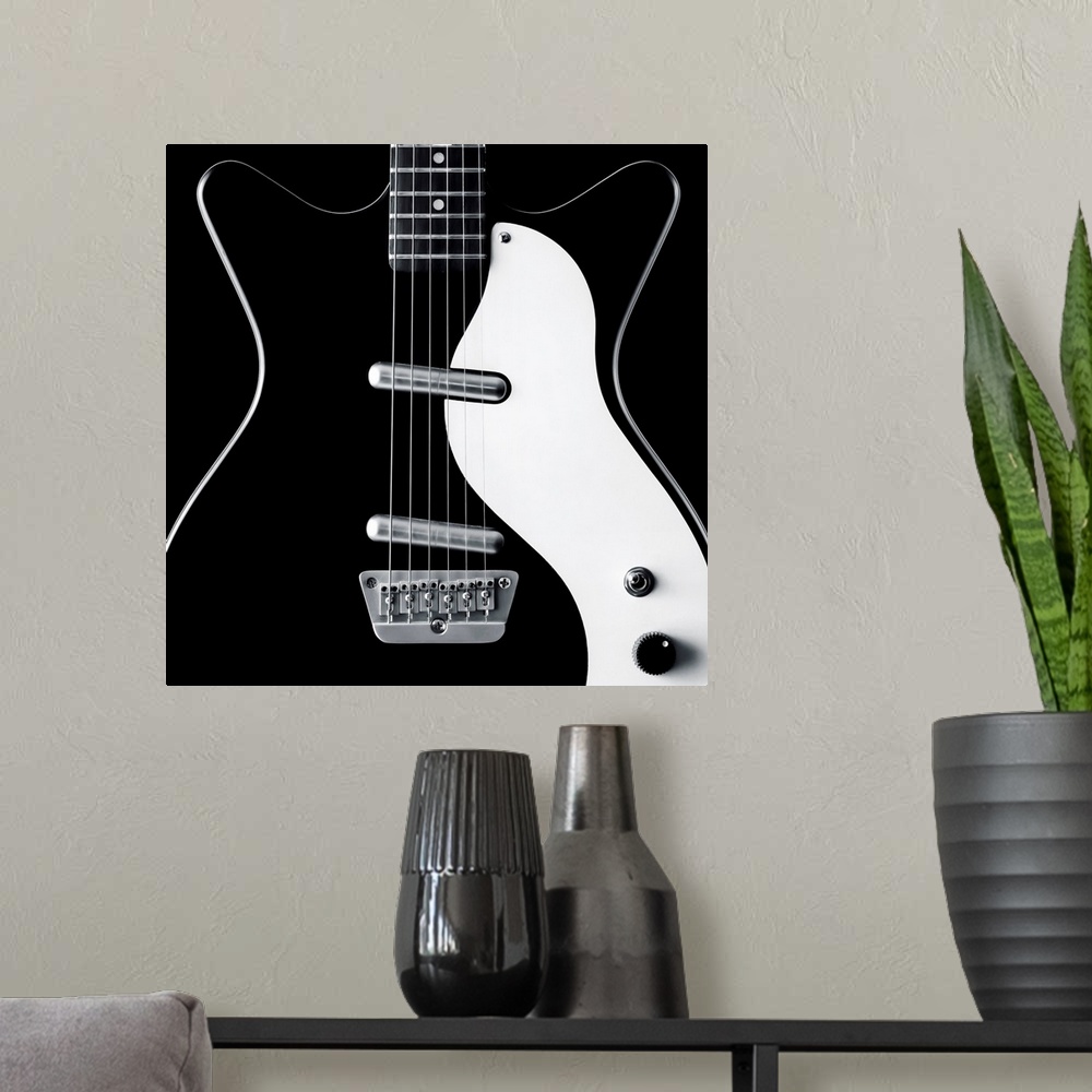 A modern room featuring Close-up of a black and white electric guitar.
