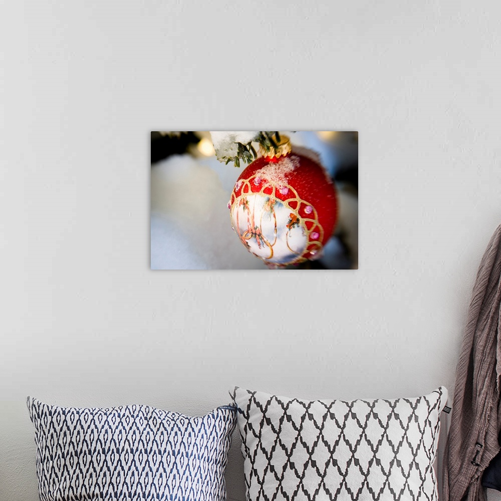 A bohemian room featuring Close up of a Christmas ornament hanging on a snowcovered branch outdoors during winter