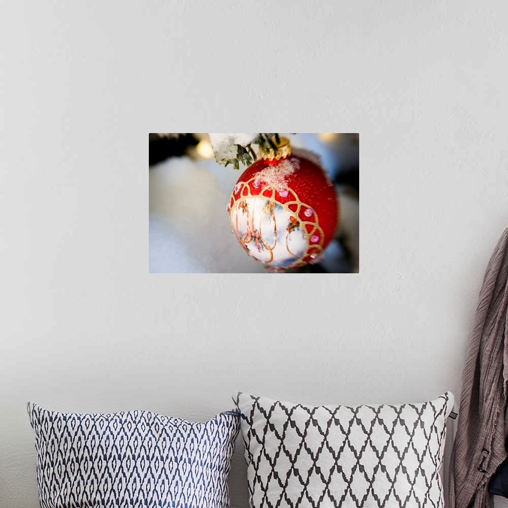 A bohemian room featuring Close up of a Christmas ornament hanging on a snowcovered branch outdoors during winter