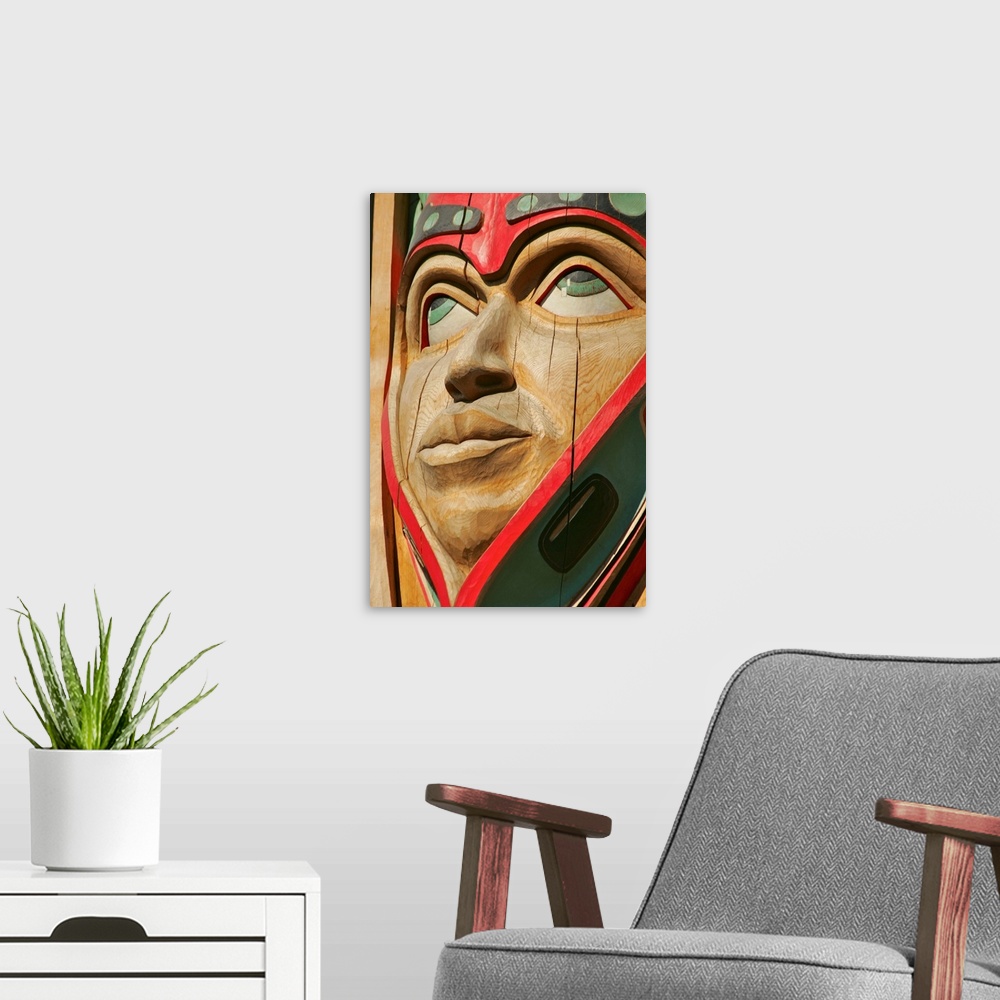 A modern room featuring Close up of a face on a traditional Haida totem carving in Ketchikan, Alaska.