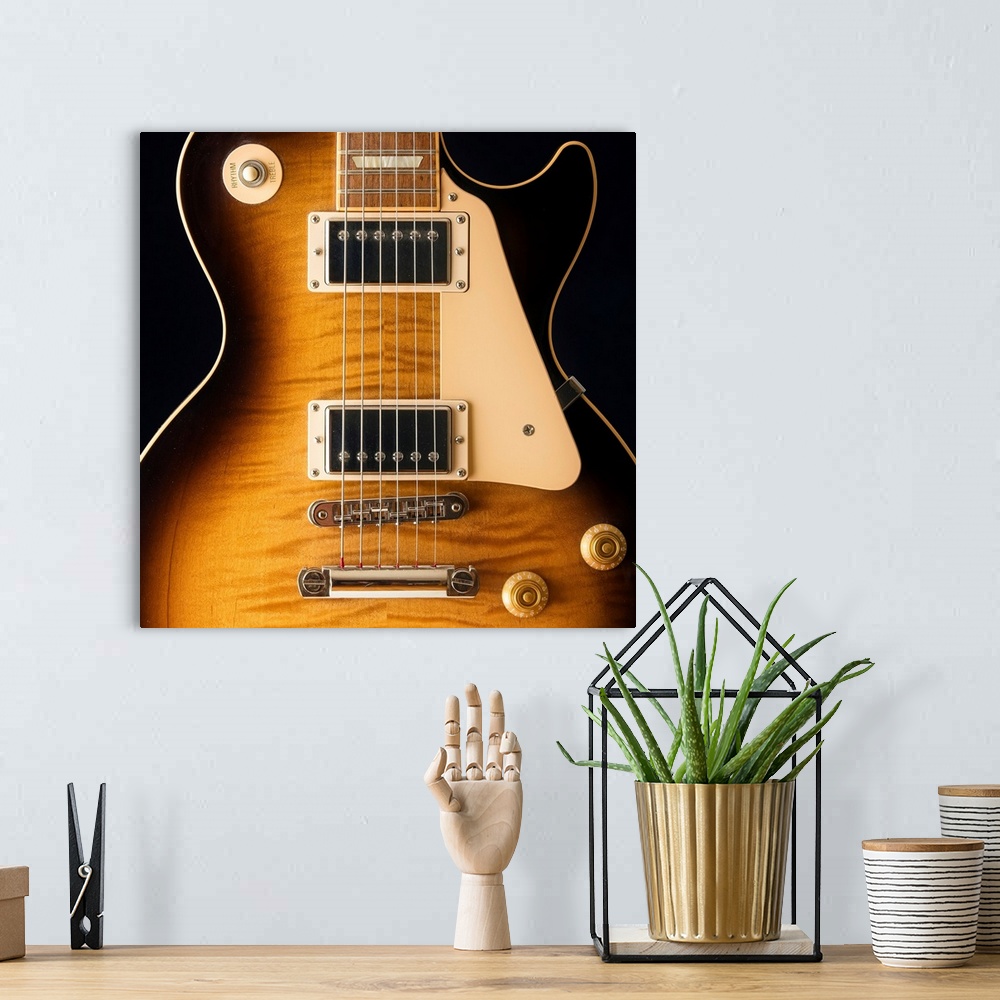 A bohemian room featuring Close-up of a single cut electric guitar.