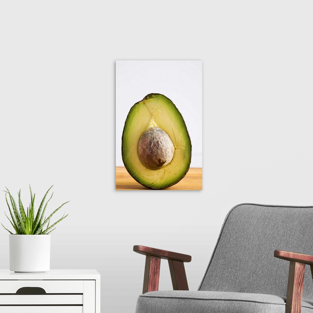 A modern room featuring Close Up Of An Avocado Standing Upright Cut In Half With The Pit