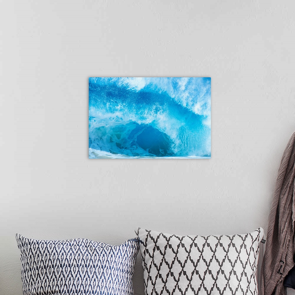 A bohemian room featuring Up-close photograph of huge swell crashing down into ocean.