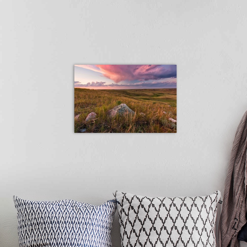 A bohemian room featuring Clouds Lit At Sunset With Some Glacial Erratics Lying In Grasslands National Park;Saskatchewan Ca...
