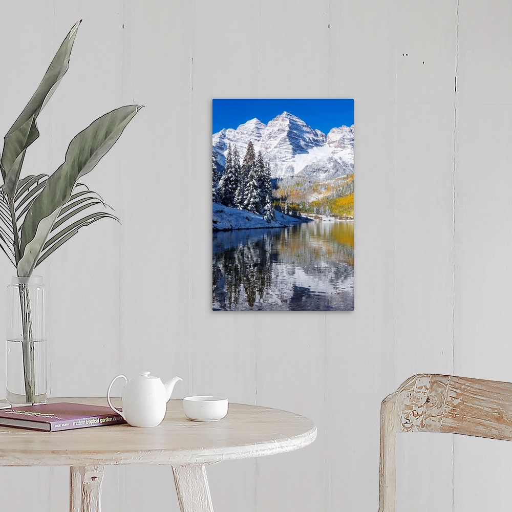 A farmhouse room featuring Snow covered mountains are pictured against a clear blue background that reflects down in the bod...