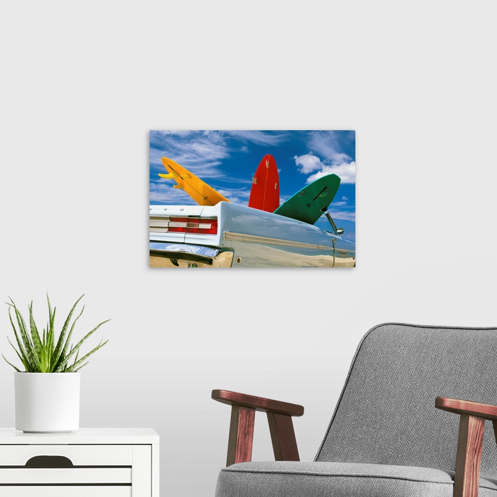 A modern room featuring Colorful Surfboards In Vintage Plymouth Fury