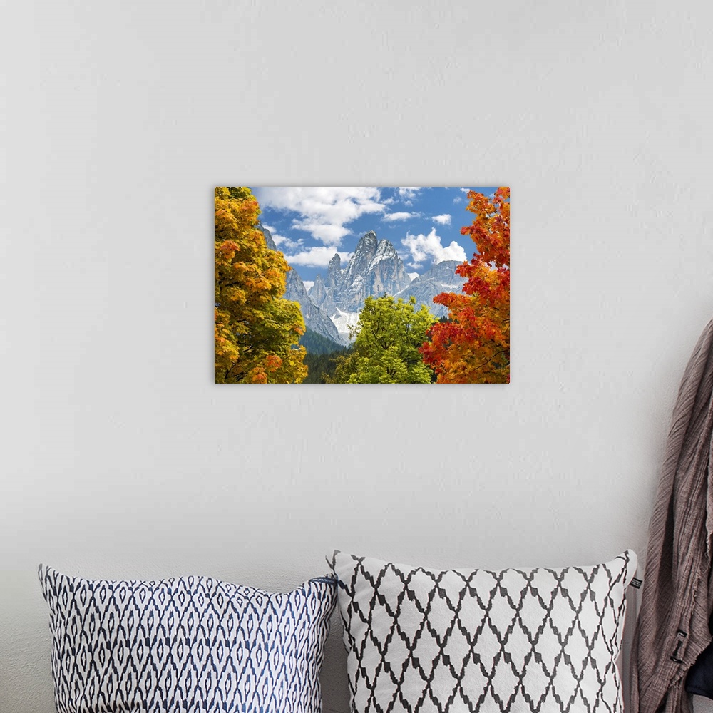 A bohemian room featuring Colourful trees in autumn framing dramatic mountain in the background; Sesto, Bolzano, Italy