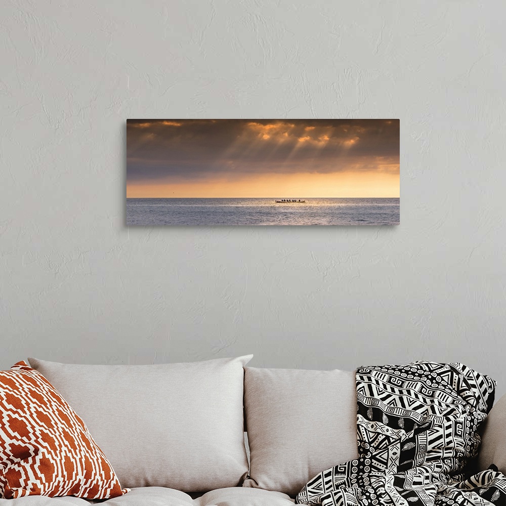 A bohemian room featuring A panoramic image of the 200 year old Cornish Pilot Gig Dove being rowed as the sun sets over Fis...