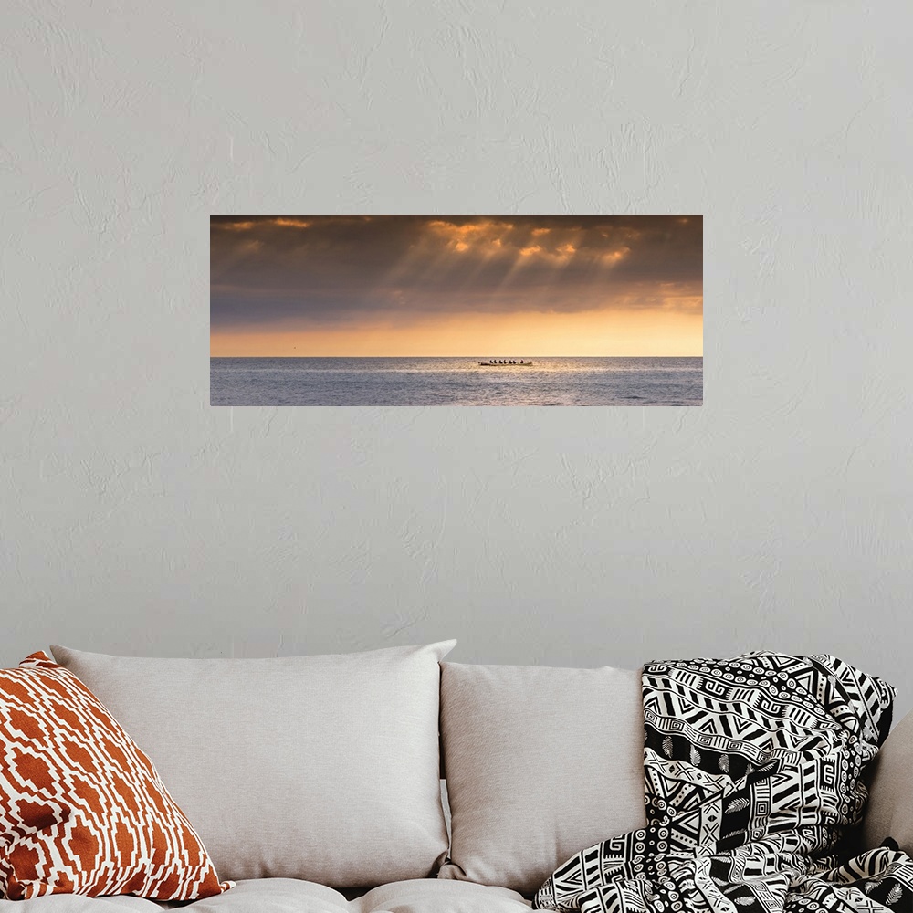 A bohemian room featuring A panoramic image of the 200 year old Cornish Pilot Gig Dove being rowed as the sun sets over Fis...