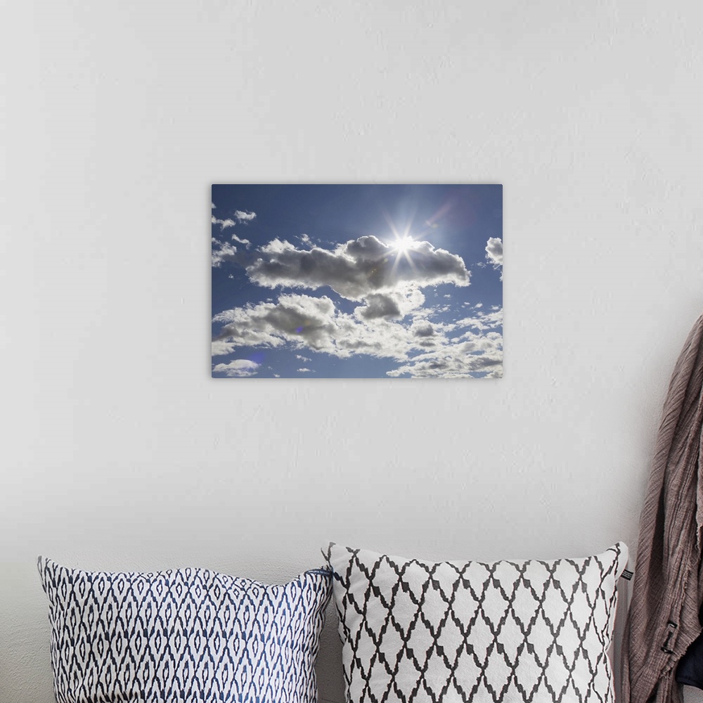 A bohemian room featuring Cumulus clouds in a blue sky with sunlight bursting from behind, Edmonton, Alberta, Canada.