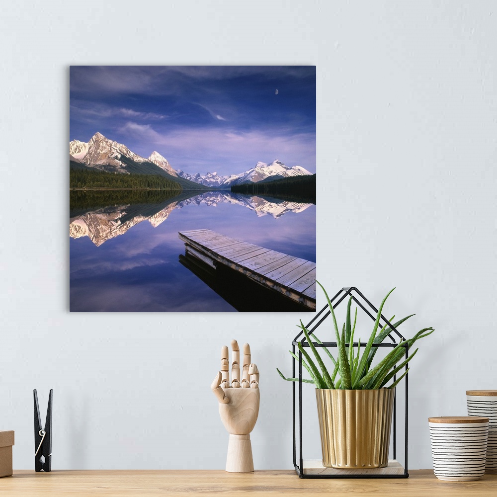 A bohemian room featuring Dock In Lake, Mountains In Background; Alberta, Canada