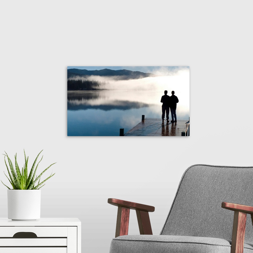 A modern room featuring Couple standing on a dock and silhoutted against the fog lifting from Lake Whatcom during Winter,...