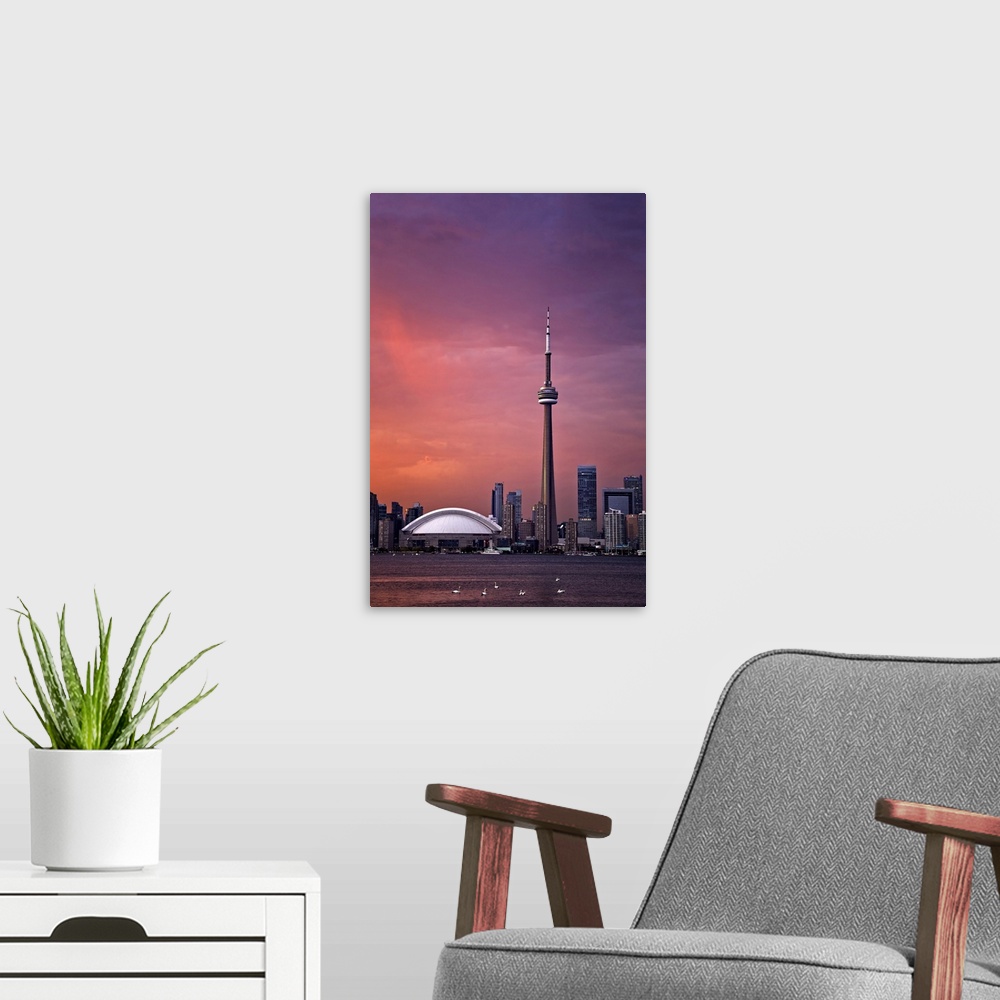 A modern room featuring Downtown Toronto across Lake Ontario at sunset.