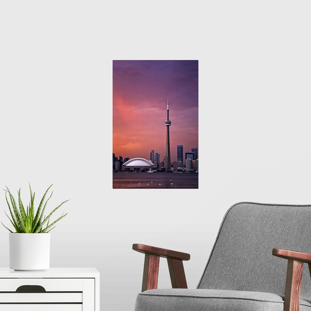A modern room featuring Downtown Toronto across Lake Ontario at sunset.