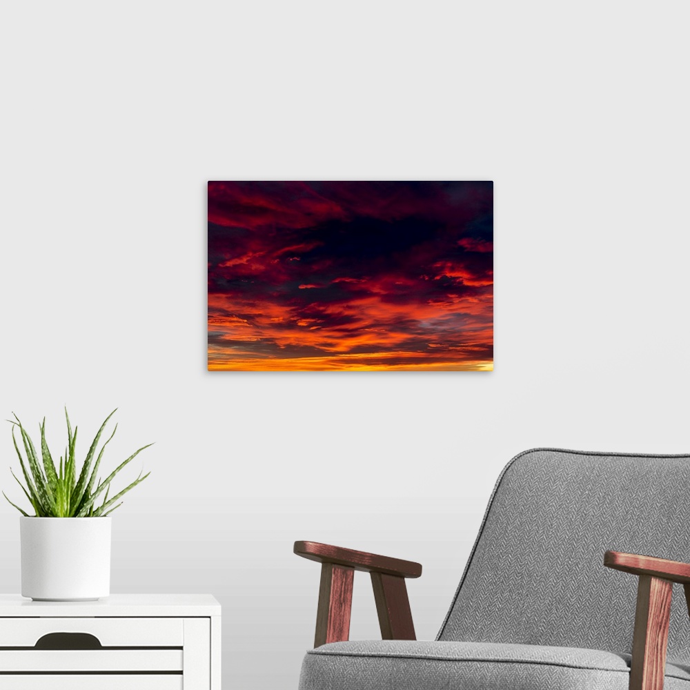 A modern room featuring Dramatic colourful cloud formations at sunset; Calgary, Alberta, Canada