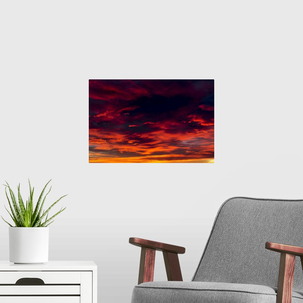 A modern room featuring Dramatic colourful cloud formations at sunset; Calgary, Alberta, Canada