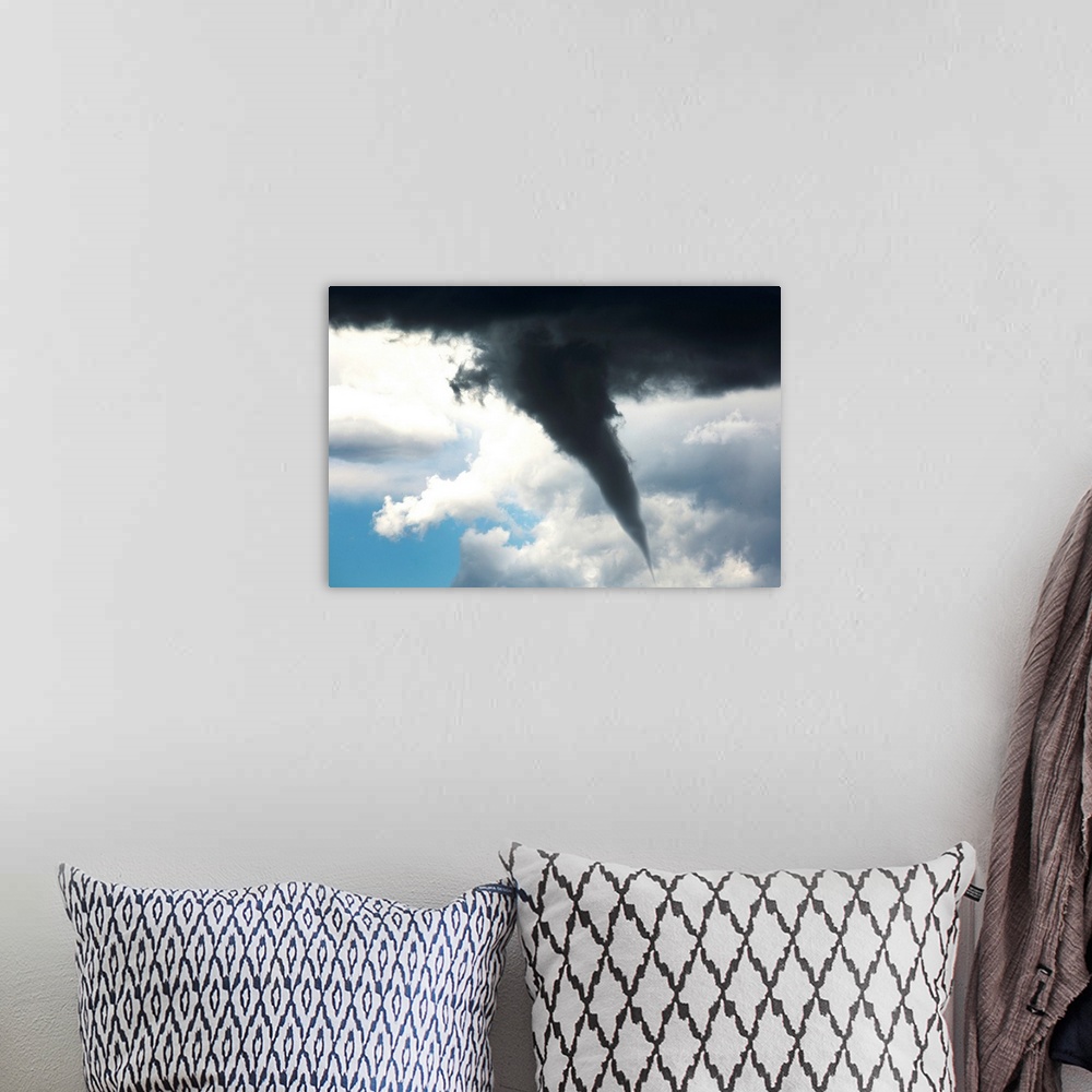 A bohemian room featuring Dramatic funnel cloud created in dark storm clouds. Calgary, Alberta, Canada.