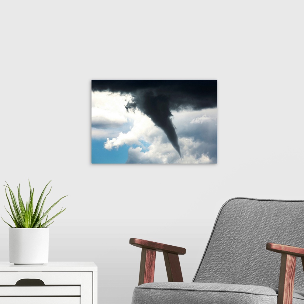 A modern room featuring Dramatic funnel cloud created in dark storm clouds. Calgary, Alberta, Canada.