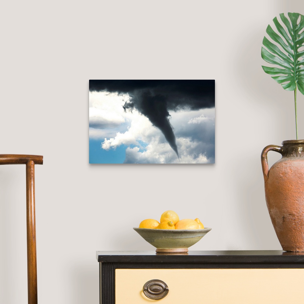 A traditional room featuring Dramatic funnel cloud created in dark storm clouds. Calgary, Alberta, Canada.