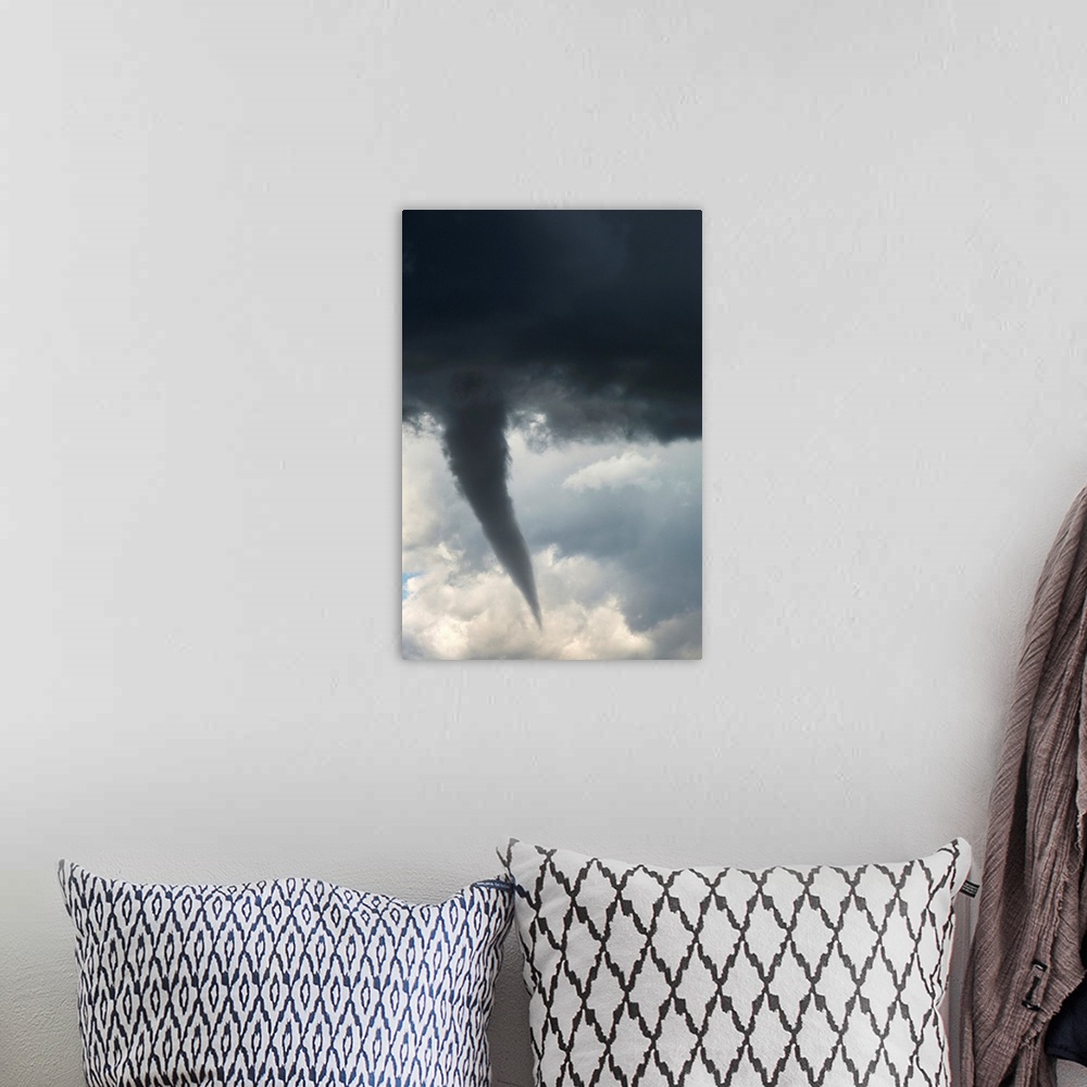 A bohemian room featuring Dramatic funnel cloud created in dark storm clouds. Calgary, Alberta, Canada.