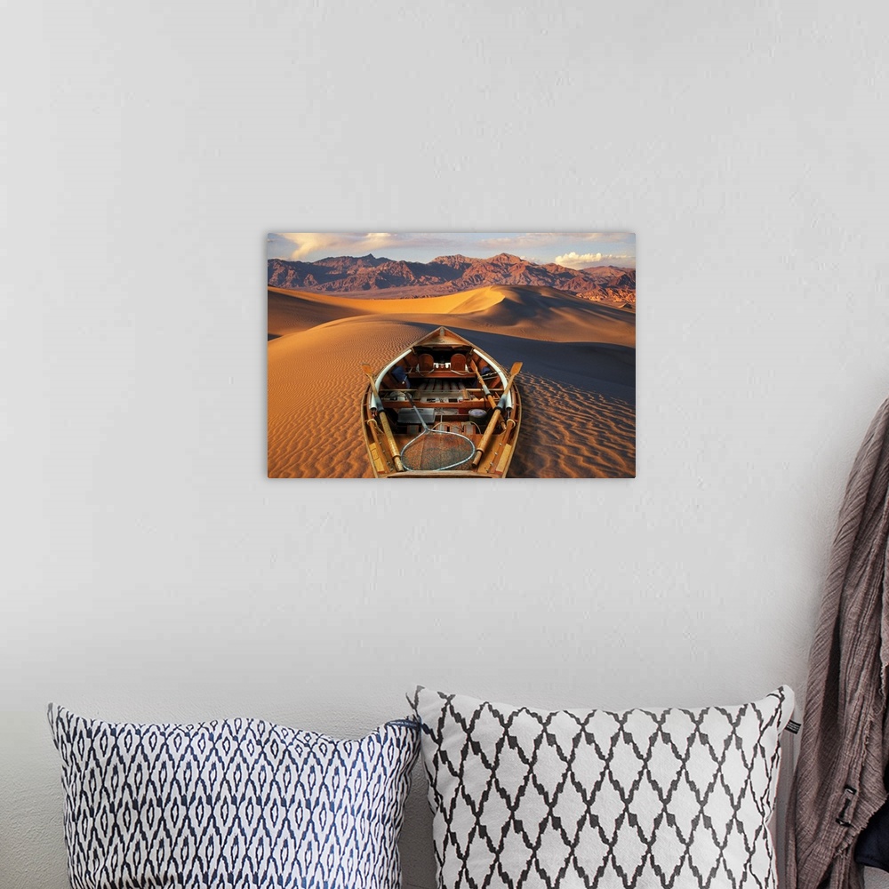 A bohemian room featuring Drift boat and Death Valley National Park sand dunes. Composite.