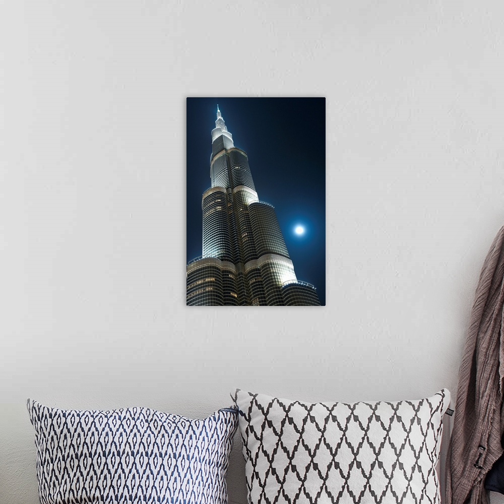 A bohemian room featuring Dubai, Uaemoon And Moving Clouds Behind The Burj Khalifa At Night