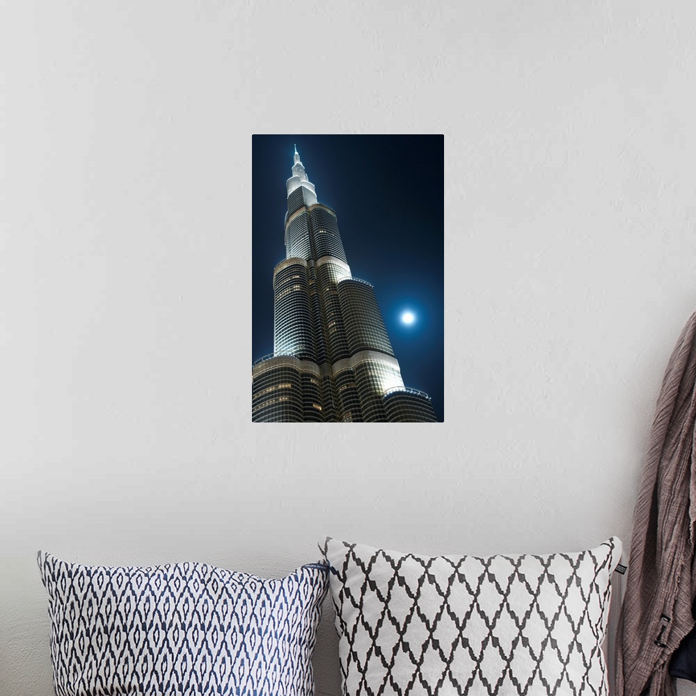 A bohemian room featuring Dubai, Uaemoon And Moving Clouds Behind The Burj Khalifa At Night