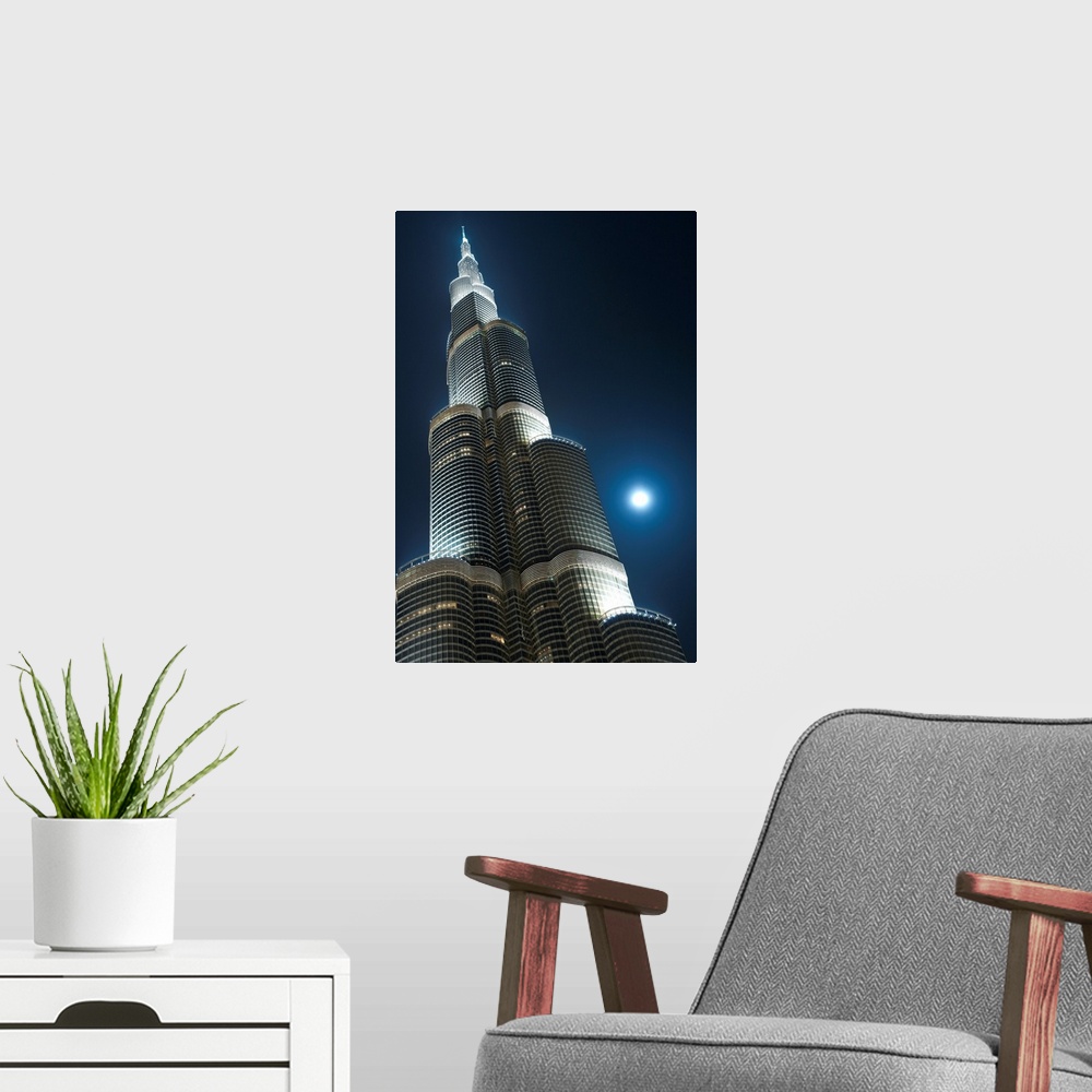 A modern room featuring Dubai, Uaemoon And Moving Clouds Behind The Burj Khalifa At Night