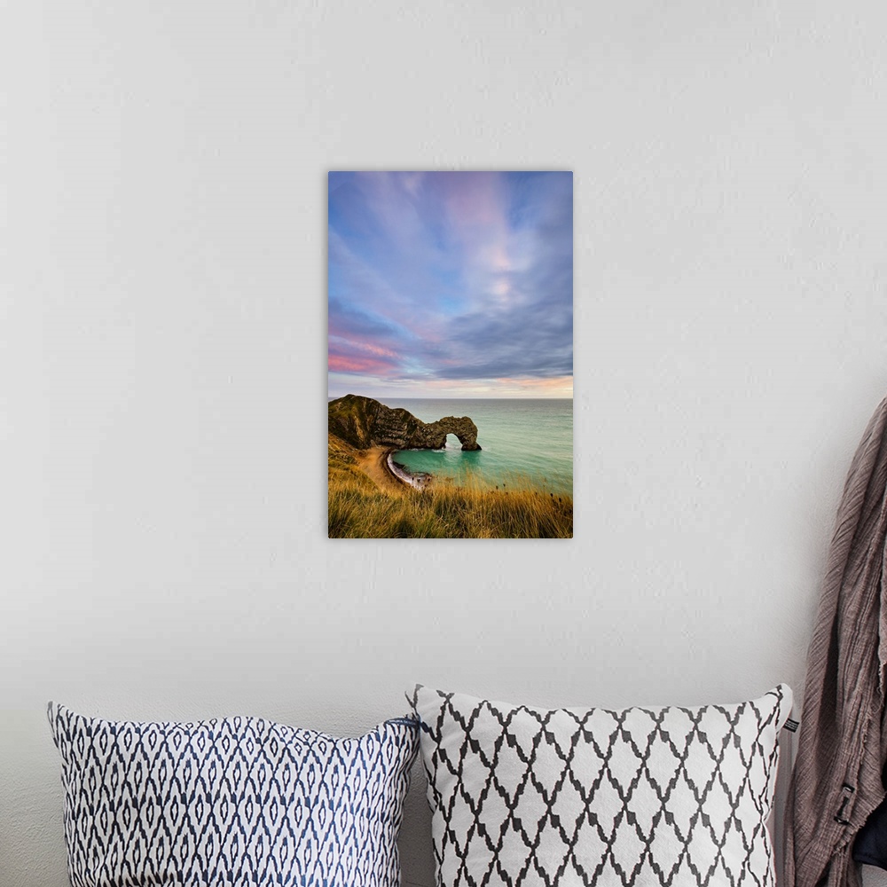 A bohemian room featuring Durdle Door at sunset.