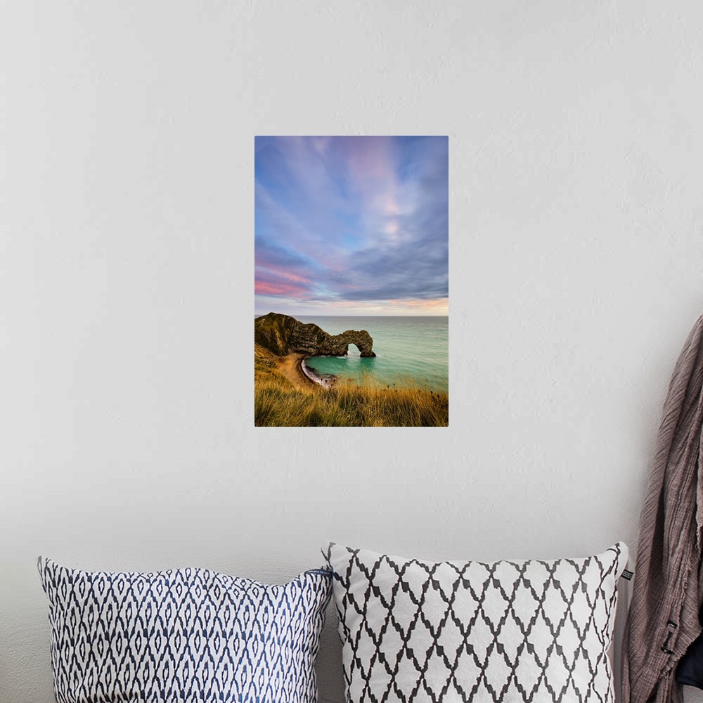 A bohemian room featuring Durdle Door at sunset.